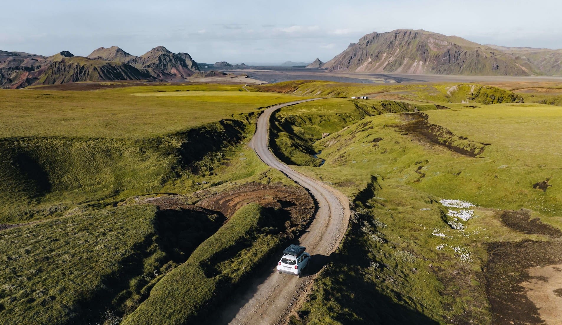 Voiture qui roule dans un paysage lors d'un voyage en Islande